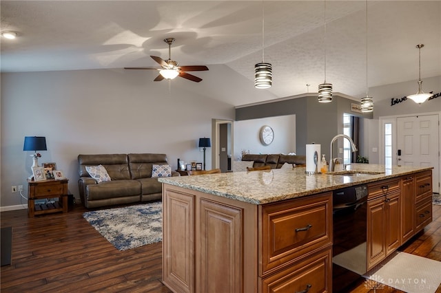 kitchen featuring a sink, open floor plan, lofted ceiling, dark wood-style flooring, and light stone countertops