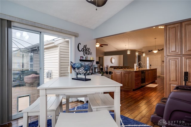 dining space featuring dark wood finished floors, lofted ceiling, and ceiling fan