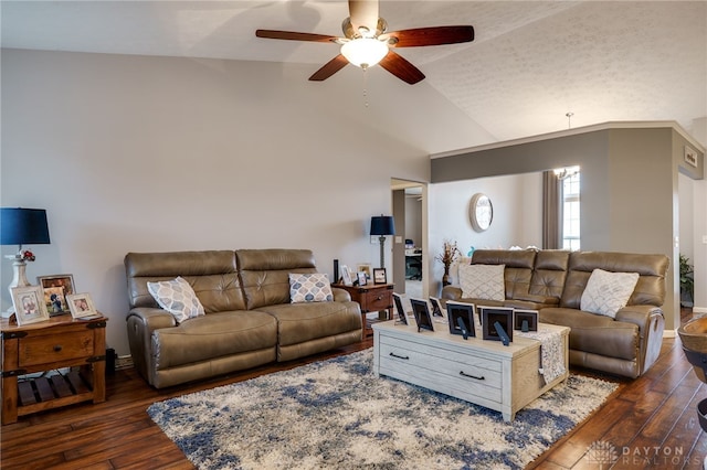 living room with baseboards, a ceiling fan, lofted ceiling, and dark wood-style flooring