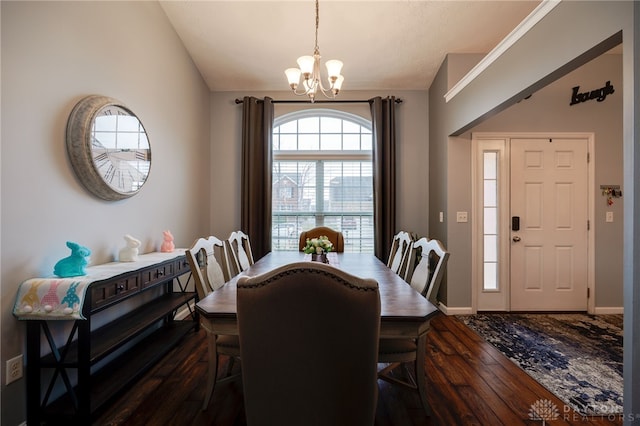 dining area with an inviting chandelier, baseboards, dark wood-style flooring, and vaulted ceiling