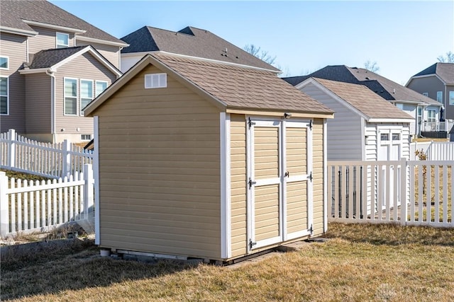 view of shed with a residential view and a fenced backyard