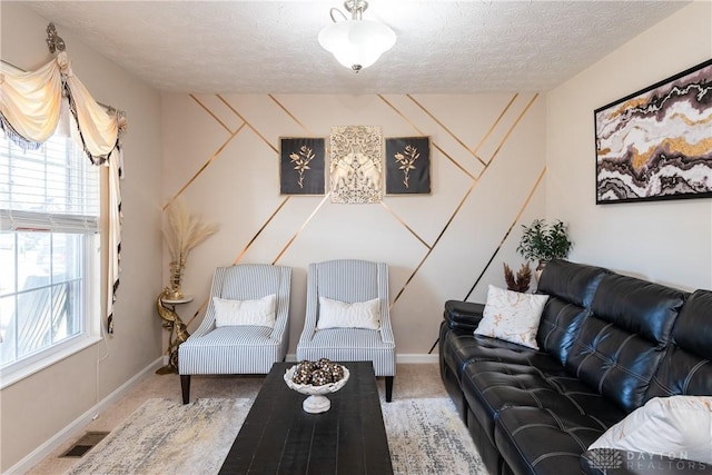 carpeted living area featuring visible vents, a textured ceiling, and baseboards