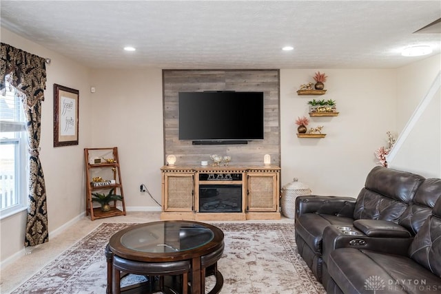 living room featuring recessed lighting, light colored carpet, baseboards, and a textured ceiling