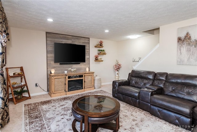 living area with light carpet, a fireplace, a textured ceiling, and baseboards