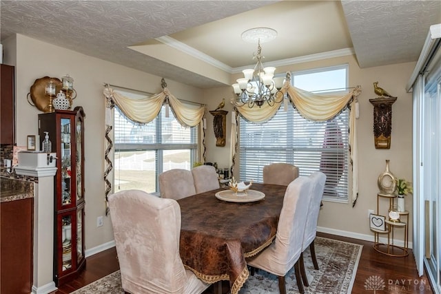 dining room with a chandelier, a textured ceiling, dark wood-type flooring, and baseboards