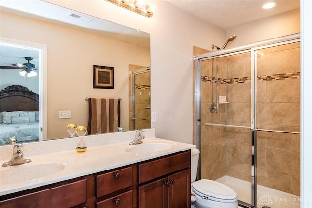 ensuite bathroom featuring a sink, connected bathroom, toilet, and a shower stall