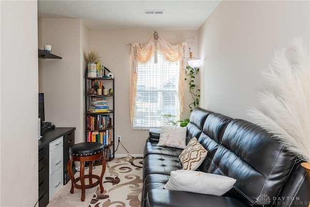 home office featuring light carpet, visible vents, and baseboards