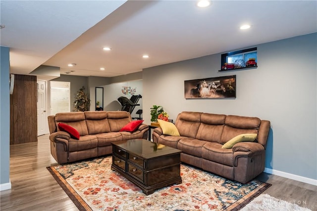 living room featuring recessed lighting, wood finished floors, and baseboards