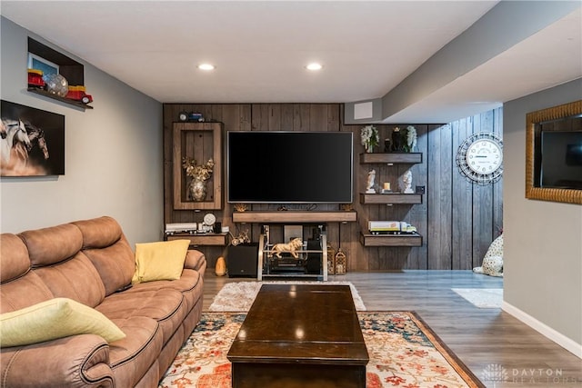 living room with recessed lighting, baseboards, and wood finished floors