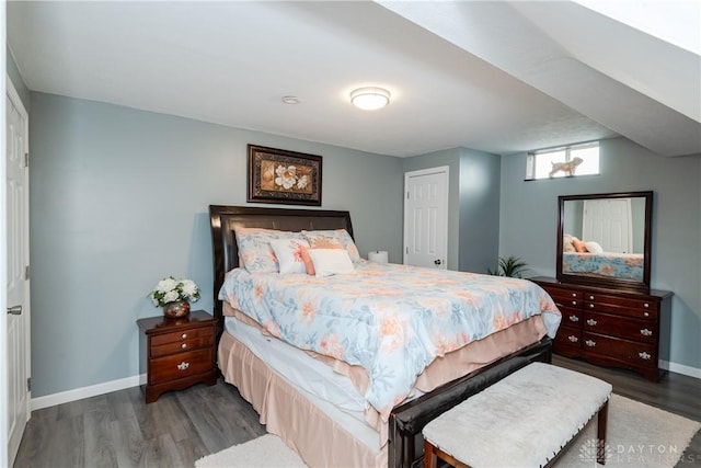 bedroom featuring wood finished floors and baseboards