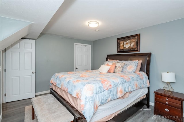 bedroom featuring baseboards and wood finished floors