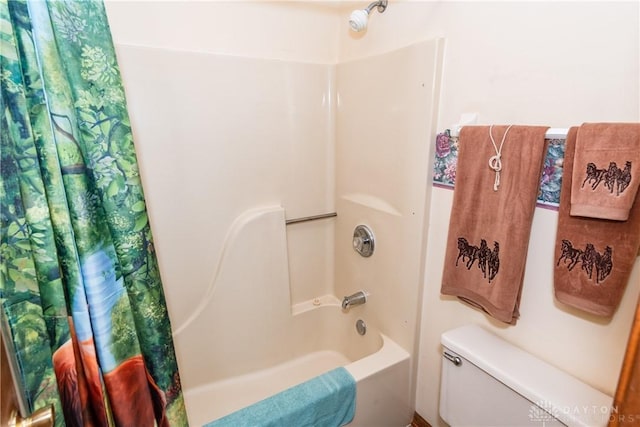 bathroom with toilet and shower / tub combo