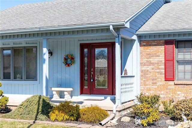 property entrance with brick siding and a shingled roof