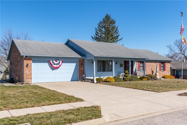 single story home with a porch, a front lawn, concrete driveway, a garage, and brick siding