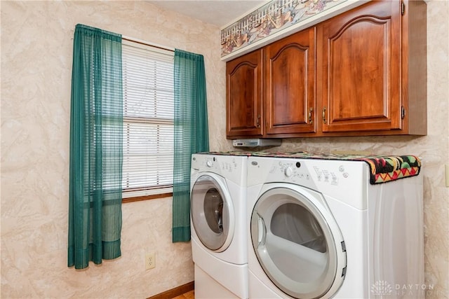 washroom with washer and dryer and cabinet space