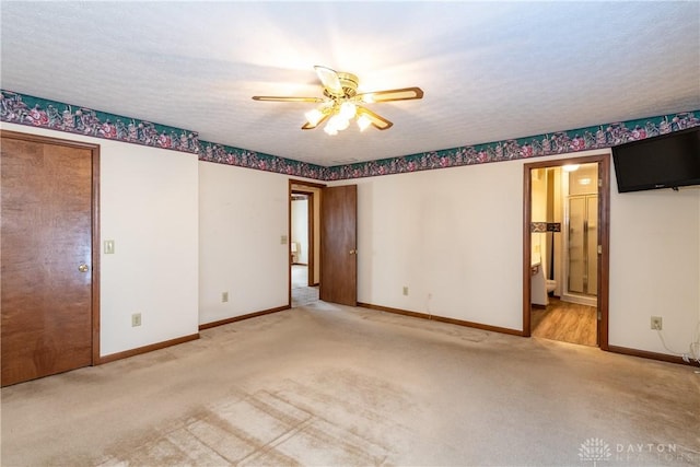 empty room with baseboards, a textured ceiling, and carpet flooring