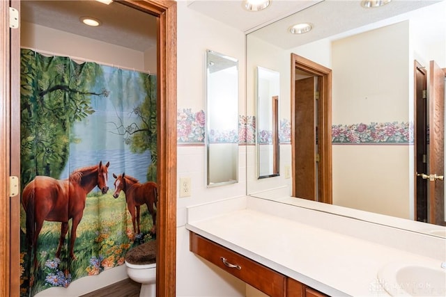 full bath with toilet and vanity