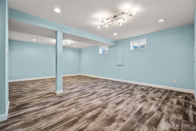 below grade area with baseboards and wood finished floors