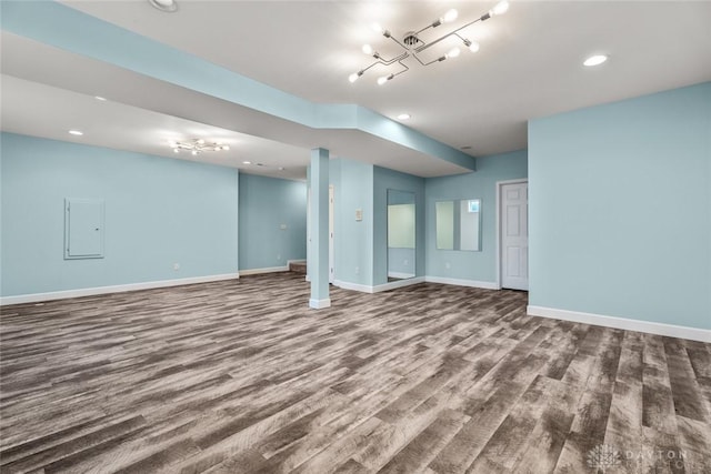 interior space with electric panel, recessed lighting, baseboards, and wood finished floors