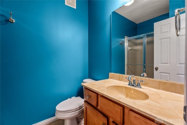 bathroom featuring visible vents, a shower stall, toilet, tile patterned floors, and vanity