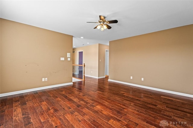 empty room with recessed lighting, baseboards, and dark wood-type flooring