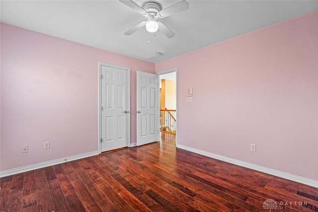 unfurnished bedroom with ceiling fan, baseboards, and hardwood / wood-style floors