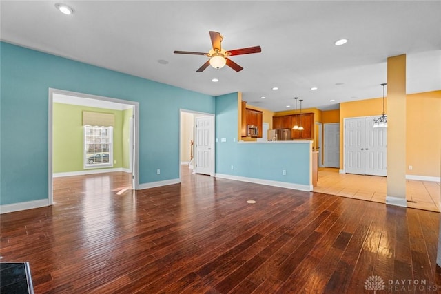 unfurnished living room with recessed lighting, ceiling fan, baseboards, and hardwood / wood-style floors