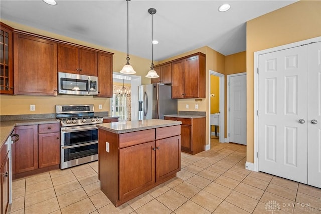 kitchen featuring a kitchen island, glass insert cabinets, decorative light fixtures, light tile patterned floors, and appliances with stainless steel finishes