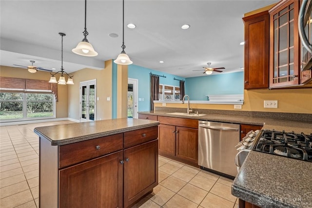 kitchen featuring a sink, dark countertops, dishwasher, and open floor plan