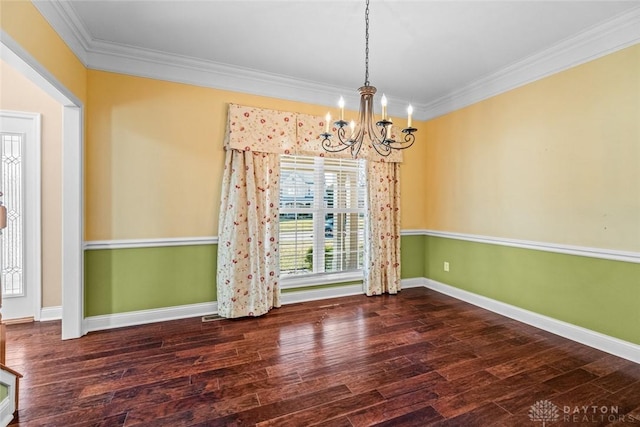 unfurnished dining area featuring a chandelier, baseboards, wood finished floors, and crown molding