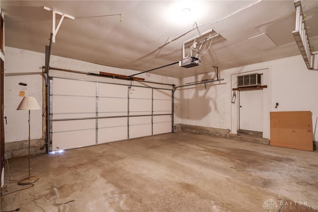 garage with a wall unit AC and a garage door opener