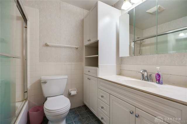 full bath featuring tile patterned floors, visible vents, toilet, tile walls, and vanity