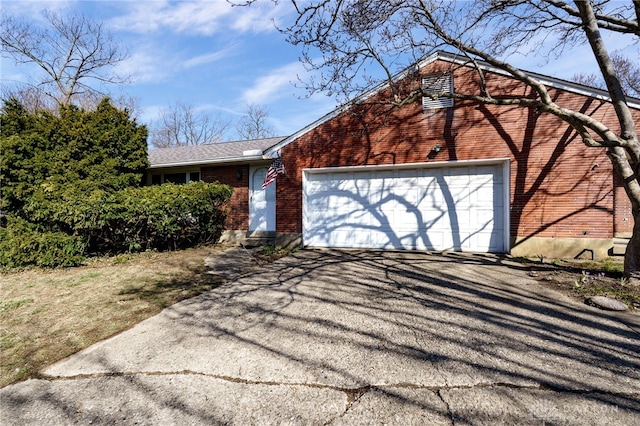 view of front of home with aphalt driveway, brick siding, and a garage