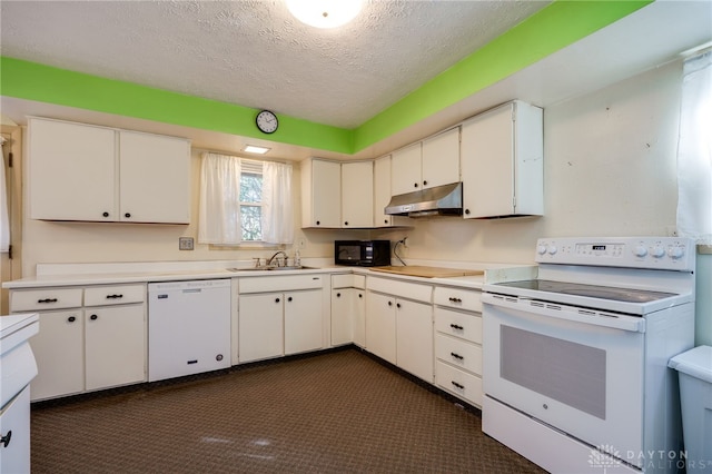 kitchen featuring white appliances, a sink, light countertops, under cabinet range hood, and a textured ceiling