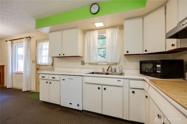 kitchen with white dishwasher, a sink, under cabinet range hood, a textured ceiling, and black microwave