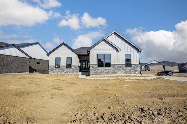 view of front of property featuring stone siding and board and batten siding