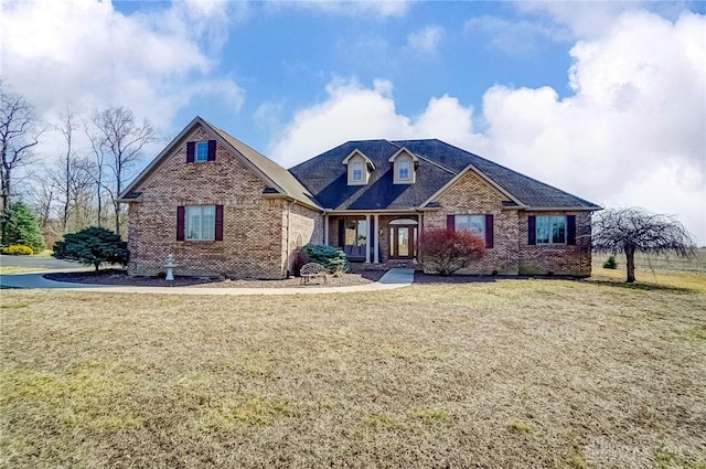 view of front of house with brick siding and a front lawn