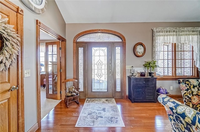 foyer featuring wood finished floors and baseboards