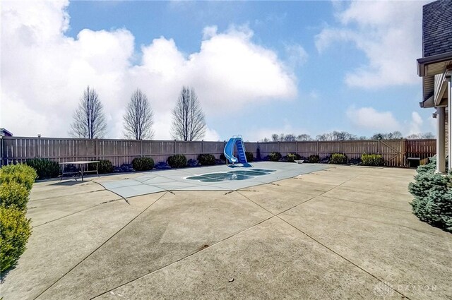 view of pool with a patio and fence