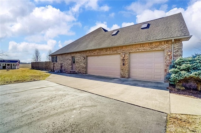 view of side of home featuring a yard, fence, driveway, and a shingled roof