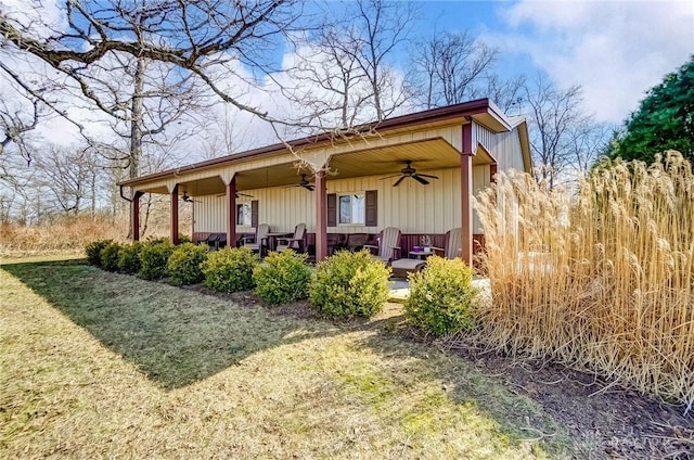 exterior space with a porch, a yard, and ceiling fan