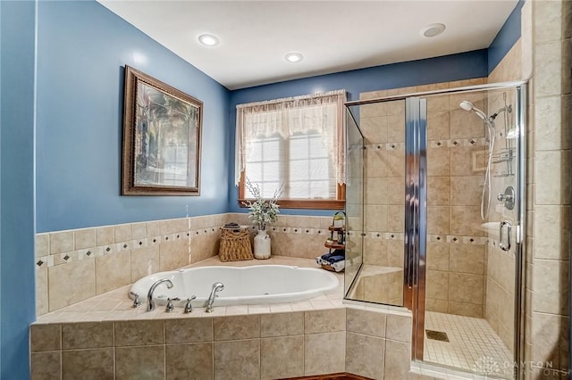 full bath with a stall shower, a bath, and recessed lighting