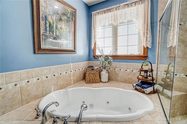 bathroom with a jetted tub and a stall shower