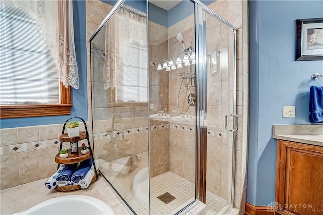 bathroom with plenty of natural light, a stall shower, and vanity