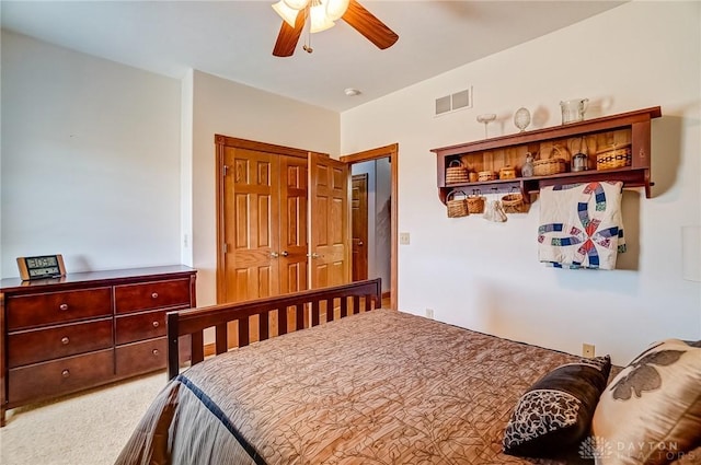 bedroom featuring carpet flooring, a ceiling fan, visible vents, and a closet