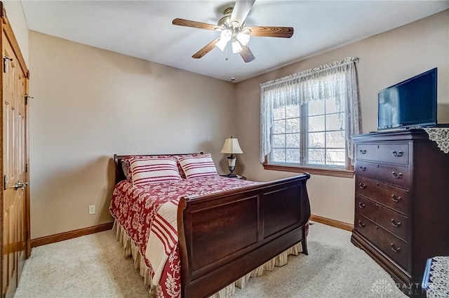 bedroom with light colored carpet, baseboards, and ceiling fan