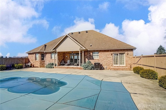 view of pool featuring a fenced in pool, a patio area, a fenced backyard, and central AC