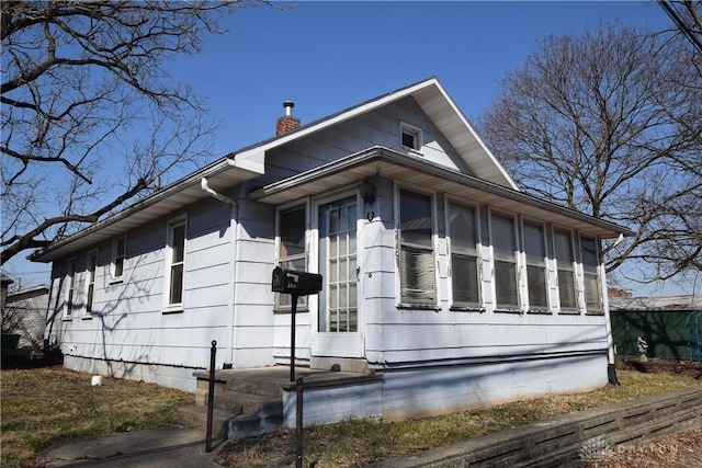 view of property exterior featuring a chimney