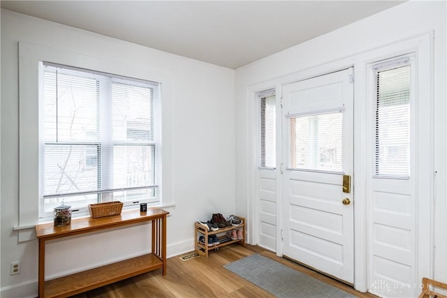 entrance foyer featuring baseboards and wood finished floors