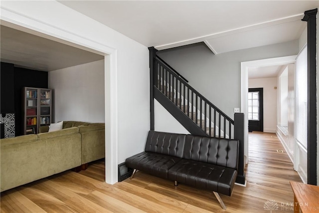 staircase with baseboards and wood finished floors